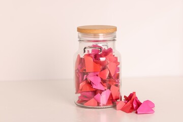 Color paper pieces in glass jar on light table