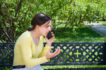 Naklejka premium Young girl speaking by phone