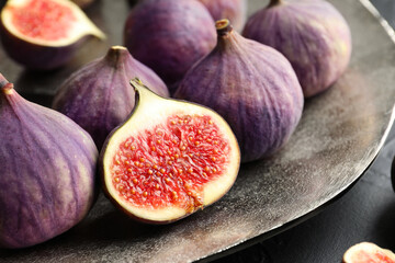 Whole and cut figs on table, closeup
