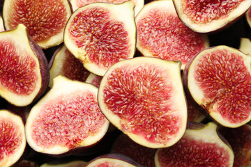 Pieces of ripe figs as background, top view