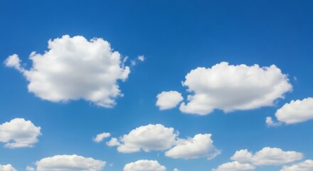 Obraz premium Bright white cumulus clouds against a clear blue sky