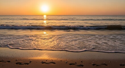 Sunset over the ocean with waves on a sandy beach
