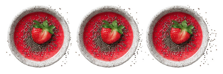 Three small, round bowls of vibrant pink smoothie topped with a single strawberry and scattered seeds