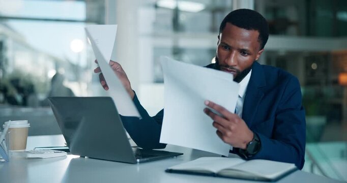 Business, black man and laptop with paperwork in office for case study, contract review or policy. Professional, lawyer or tech with documents at law firm for reading legal report or lawsuit evidence