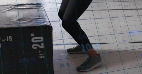 Bending legs in black leggings in gym, with labeled plyo box and grid overlay, copy space