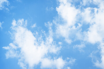 Beautiful daylight sky with scattered clouds. Clear blue sky with light white clouds floating. Sky background for websites, presentations, flyers and creative projects.