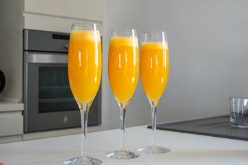 Fresh, delicious mimosas served in elegant flutes, showcasing vibrant orange color, perfect for a festive party atmosphere with sparkling bubbles and joyful celebration concept