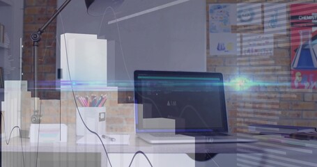 Laptop computer displaying code interface and data graph in home office with pencil holder, lamp