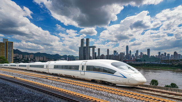 Modern high-speed train running on urban railway with cityscape in background