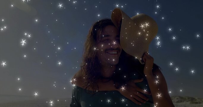 Adult man carrying partner piggyback on sandy beach dunes, with wide-brimmed straw sun hat - Powered by Adobe
