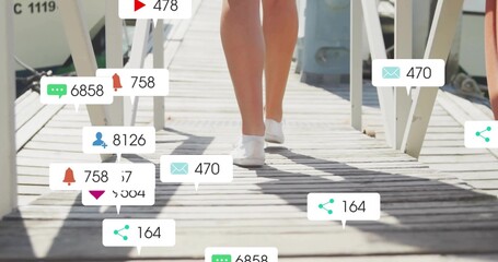 Walking teenager wearing white sneakers on wooden dock, with floating social media notifications