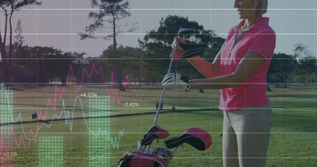 Golfer in pink polo holding club inspecting line charts on fairway, golf bag, glove, copy space