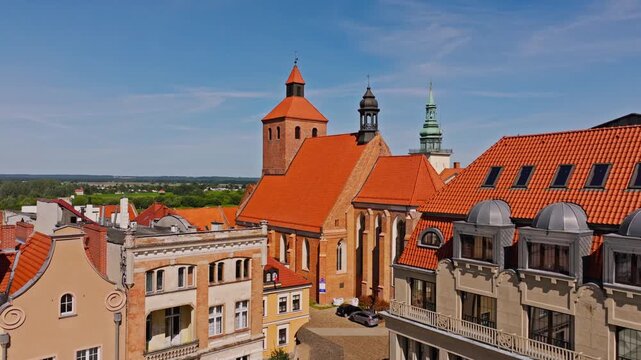 Drone captures Grudziadz skyline with red rooftops and historic church walls