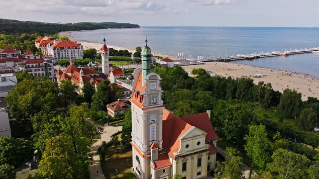 Sopot drone orbit around Salvator's Church with beach and sea in background