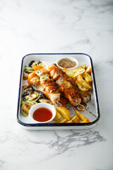 Traditional chicken skewers with roasted vegetables