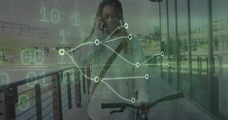 Walking man pushing bicycle along path by glass facade, holding smartphone amid binary code overlay
