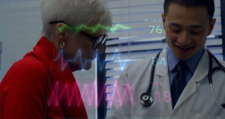 Leaning senior patient and doctor examining vitals display in clinic with stethoscope, copy space