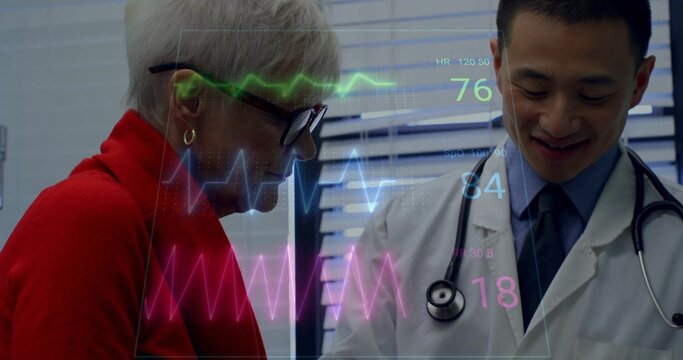 Leaning senior patient and doctor examining vitals display in clinic with stethoscope, copy space - Powered by Adobe