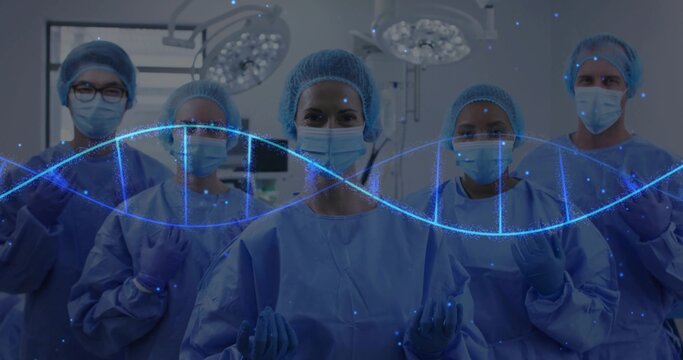 Standing five surgeons wearing surgical attire in operating room, with DNA double-helix overlay