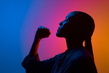 A dark outline of a woman with a raised fist is positioned against a colorful gradient background, signifying the strong and unifying spirit of freedom and empowerment