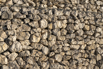 Gabion wall protecting a slope with wire mesh and rocks