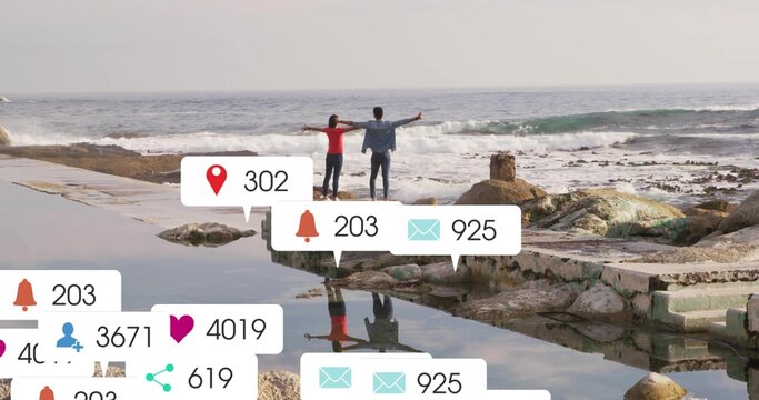 Stretching couple facing ocean on coastal platform, with notification icons floating - Powered by Adobe