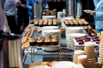 Catering banquet table with assorted snacks, desserts, pastries and appetizers, luxury food service arrangement for corporate event, wedding or festive celebration
