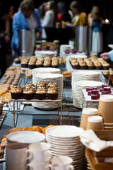 Catering banquet table with assorted snacks, desserts, pastries and appetizers, luxury food service arrangement for corporate event, wedding or festive celebration