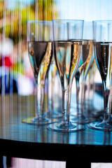 Close-up of champagne glasses filled with sparkling wine, elegant celebration table setting for festive party, wedding, New Year or luxury corporate event