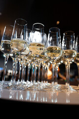 Close-up of champagne glasses filled with sparkling wine, elegant celebration table setting for festive party, wedding, New Year or luxury corporate event