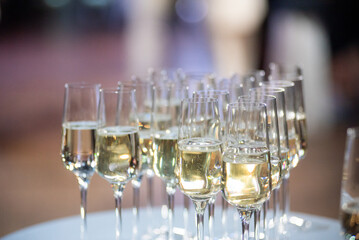 Close-up of champagne glasses filled with sparkling wine, elegant celebration table setting for festive party, wedding, New Year or luxury corporate event