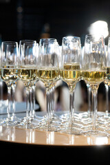 Close-up of champagne glasses filled with sparkling wine, elegant celebration table setting for festive party, wedding, New Year or luxury corporate event