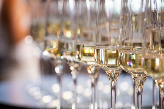Close-up of champagne glasses filled with sparkling wine, elegant celebration table setting for festive party, wedding, New Year or luxury corporate event