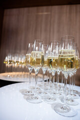 Close-up of champagne glasses filled with sparkling wine, elegant celebration table setting for festive party, wedding, New Year or luxury corporate event