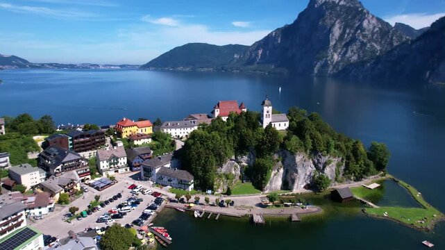 Austria Traunsee aerial flight to Traunkirchen monastery and mountain background drone 4k scenic village peninsula Salzkammergut travel destination