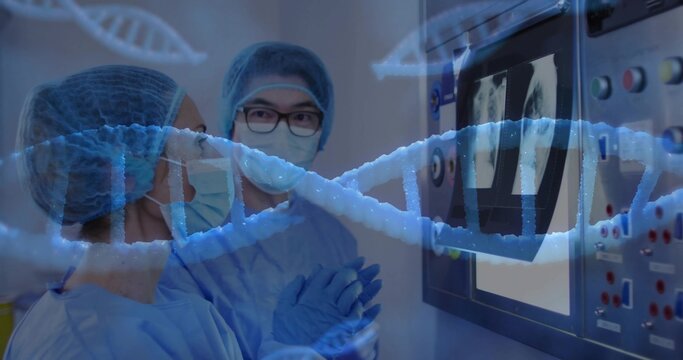 Doctors wearing surgical masks and gowns reviewing X-ray scans and DNA helix at lab control panel