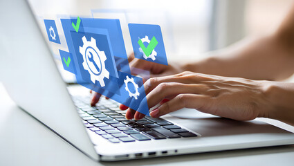 Hands typing on a laptop computer with digital interface and gears overlay