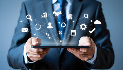 Businessman in suit using a smartphone with digital icons and network connections floating above