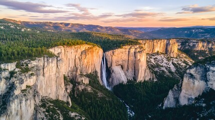 Majestic waterfall cascading down sheer granite cliffs at sunset surrounded by pine forests and distant mountains