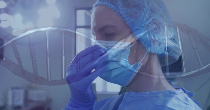 Adjusting surgical mask, surgeon wearing gown and purple gloves in operating room with DNA graphic - Powered by Adobe