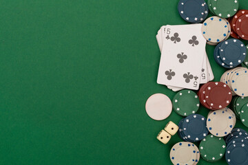 Poker chips and playing cards on color background, top view. Casino card game