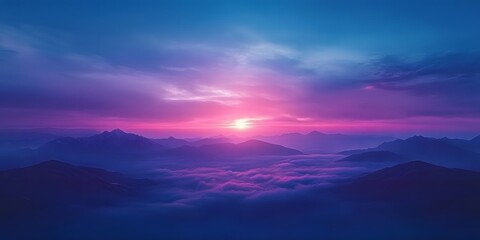 Majestic mountains shrouded in pink and purple clouds at sunrise bathed in ethereal light