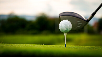 Golf ball on green grass in the evening golf course with sunshine background.