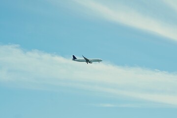 White airplane flying in blue sky over São Miguel, Azores