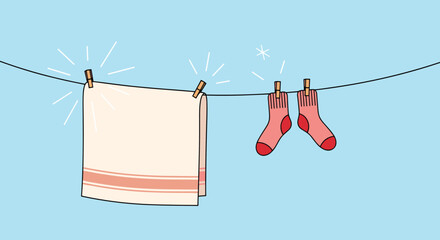 Freshly washed towel and socks drying on a clothesline under a clear blue sky