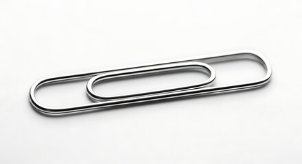 Large metallic paperclip on white background.
