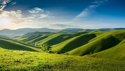 Fototapeta premium Breathtaking Scenery Of Rolling Green Hills Under A Serene Sky Ideal For Nature Lovers And Landscape Enthusiasts