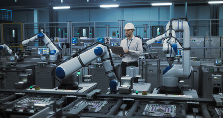 Portrait of a Caucasian Engineer in a Hard Hat Working in an Industrial Facility. Industrial...