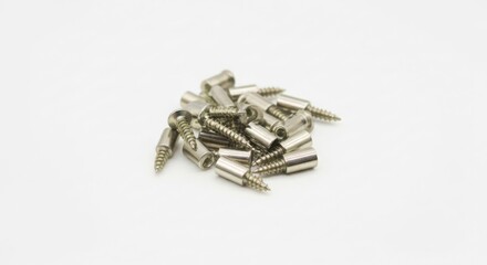 A pile of small silver metal connectors on a white background