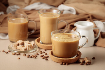 Latte with brown sugar on a beige background.